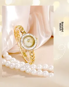 Macro shot of gold bracelet watch with zircon bezel and white mother of pearl dial