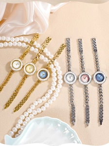 Detailed top view of luxury quartz watches with colorful mother-of-pearl dials and metal straps
