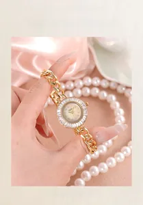Detail of GEDI gold ladies watch with mother of pearl dial and crystal bezel