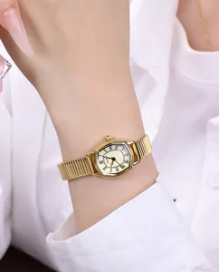 Detail of tonneau gold watch showing 30m water resistance and Roman numeral dial