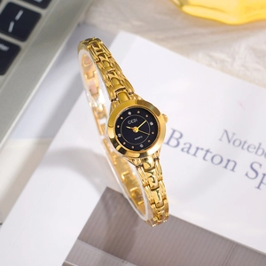 GEDI luxury gold chain watch for women with black rhinestone dial on desk
