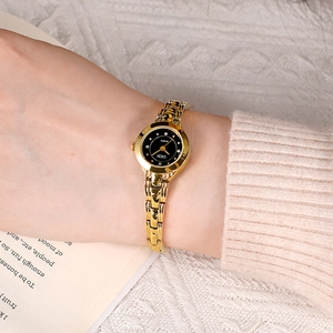 Elegant gold-tone women's quartz watch with a black dial and stylish chain bracelet