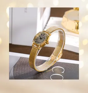 Macro detail of gold tonneau watch dial with Roman numerals on elegant white gift box