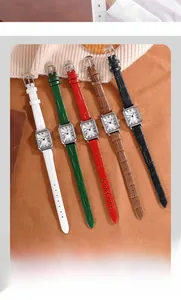 Close-up of five square vintage watches with embossed leather straps and Roman numeral dials