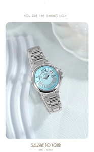 Macro view of Tiffany blue dial with Roman numerals and calendar window on silver watch