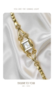 Detail of luxury gold square watch with unique horseshoe chain strap on silk background