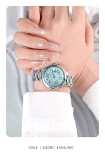 Close-up of GEDI silver steel watch with sky blue roman dial and date window