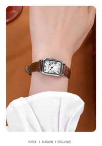 Close-up of GEDI vintage square watch with brown leather strap and roman numeral dial