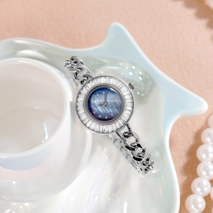 Elegant silver quartz watch for women with blue dial and crystals on star ceramic tray