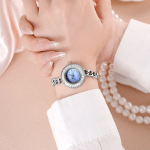 Elegant silver bracelet watch with mother-of-pearl dial and crystal bezel on wrist