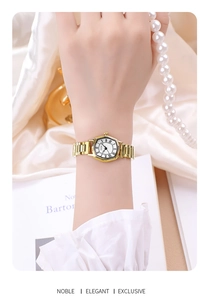 Detailed close-up of a tonneau gold watch with roman numerals on a silk background