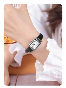 Classic silver rectangular watch with black leather strap worn by a female model