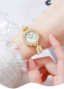 Detail of GEDI pearl bracelet watch with floral mother of pearl dial and gold accents