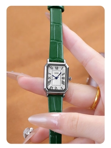 Close-up of GEDI vintage square watch with silver case and green crocodile leather strap