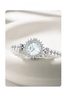 Macro shot of GEDI silver watch with pearl strap and diamond-encrusted floral bezel