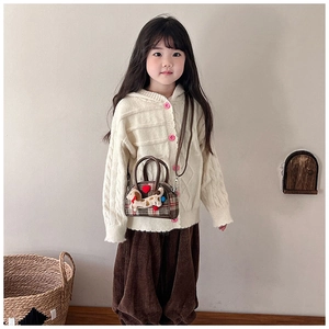 Detail of child wearing brown plaid puppy handbag with red heart and 3D ears