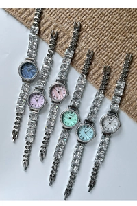 Close-up of assorted mother-of-pearl dial watches with cubic zirconia metal straps