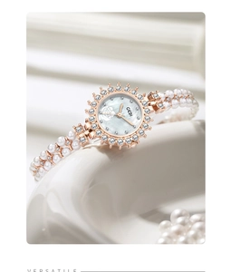 Macro shot of GEDI women's watch featuring a mother-of-pearl dial and pearl bracelet