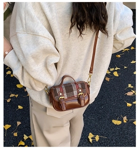 Mini plaid crossbody bag with vintage leather base shown in an autumn street setting