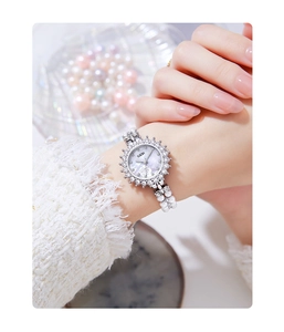 Close-up of GEDI watch with mother of pearl floral dial and double-row pearl bracelet