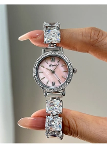 Detail of pink mother-of-pearl dial with zircon bracelet watch and crystal bezel