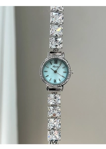 Macro shot of silver quartz watch featuring light blue sunray dial and zircon bracelet