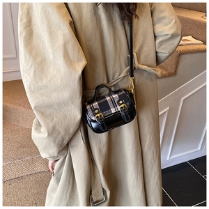 Detail of vintage wool plaid girls crossbody bag with black glossy leather and gold buckle