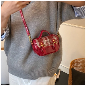 On-body view of a vintage red plaid mini crossbody bag for girls with gold hardware