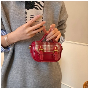 Detail view of the red plaid wool and glossy leather shoulder bag for young girls