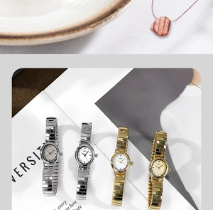Elegant oval women's quartz watches with gold and silver mesh bands on a magazine