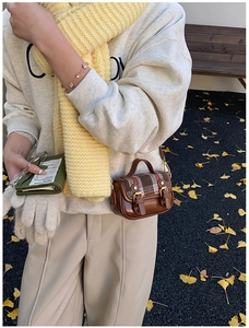 Detail of vintage brown plaid wool shoulder bag with double buckle closure for girls