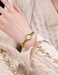 Close-up of elegant gold octagonal watch on wrist with a luxury chain bracelet band