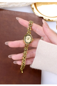 Detailed view of women's octagon gold watch with a unique vintage bracelet link strap