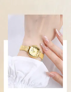 Close-up of GEDI women's gold square quartz watch with textured mesh steel strap