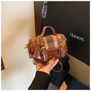 Detail of vintage plaid wool and brown leather mini shoulder bag for girls with gold buckles