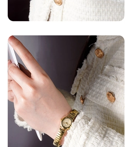 Close-up of elegant CCDI gold women watch paired with a white tweed luxury jacket