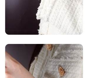 Macro shot of white tweed fabric texture with gold embossed buttons and frayed edges