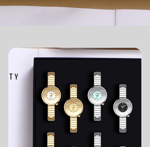 Close-up of GEDI quartz watches with crystal scales and metallic stretch bands