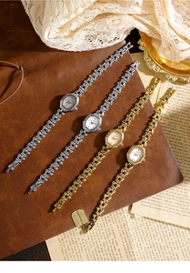 Macro shot of elegant octagonal ladies watches with unique bone-style metal chain bracelets