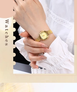 Close-up of a women's gold quartz watch with a square dial and mesh steel strap