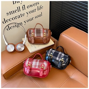 Detail of vintage plaid wool shoulder bags in three colors with dual buckle straps