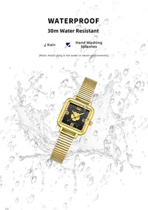 Detail of square gold watch with floral dial and splash effect showing 30M waterproof rating