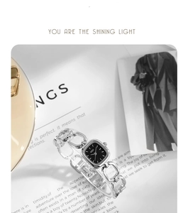 Macro detail of a silver square quartz watch with stylish hollow chain bracelet strap