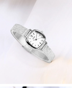 Close-up of a silver square quartz watch with a brushed stainless steel strap for women