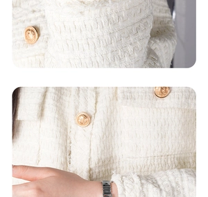 Detail of tweed jacket with fringed edges and decorative gold embossed buttons