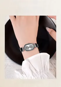 Close-up of elegant oval quartz watch with silver metal and black circular link strap