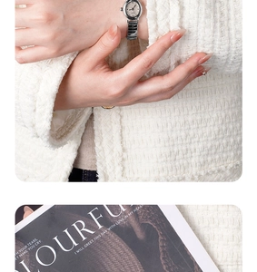 Elegant oval dial silver quartz watch for women styled with a luxury tweed jacket