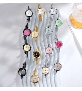 Dettaglio macro di quadranti colorati con bracciali in metallo intrecciato su supporto