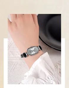 Detail of Gedi oval quartz watch with elegant silver and black artistic chain strap