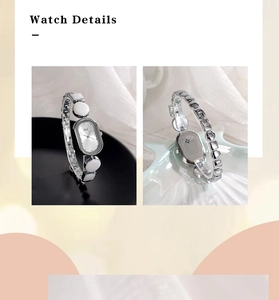 Macro shot of silver oval quartz watch with elegant bracelet strap and engraved case back